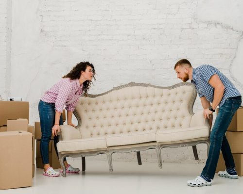 couple-moving-sofa_23-2147758716