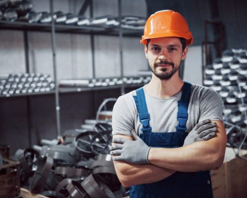 portrait-young-worker-hard-hat-large-metalworking-plant_146671-19570