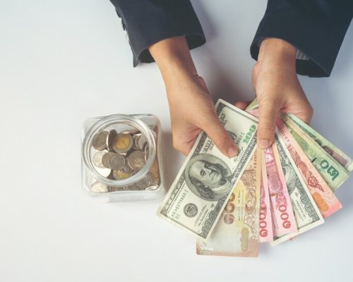 woman-employees-counting-money-white-desk_1150-20639